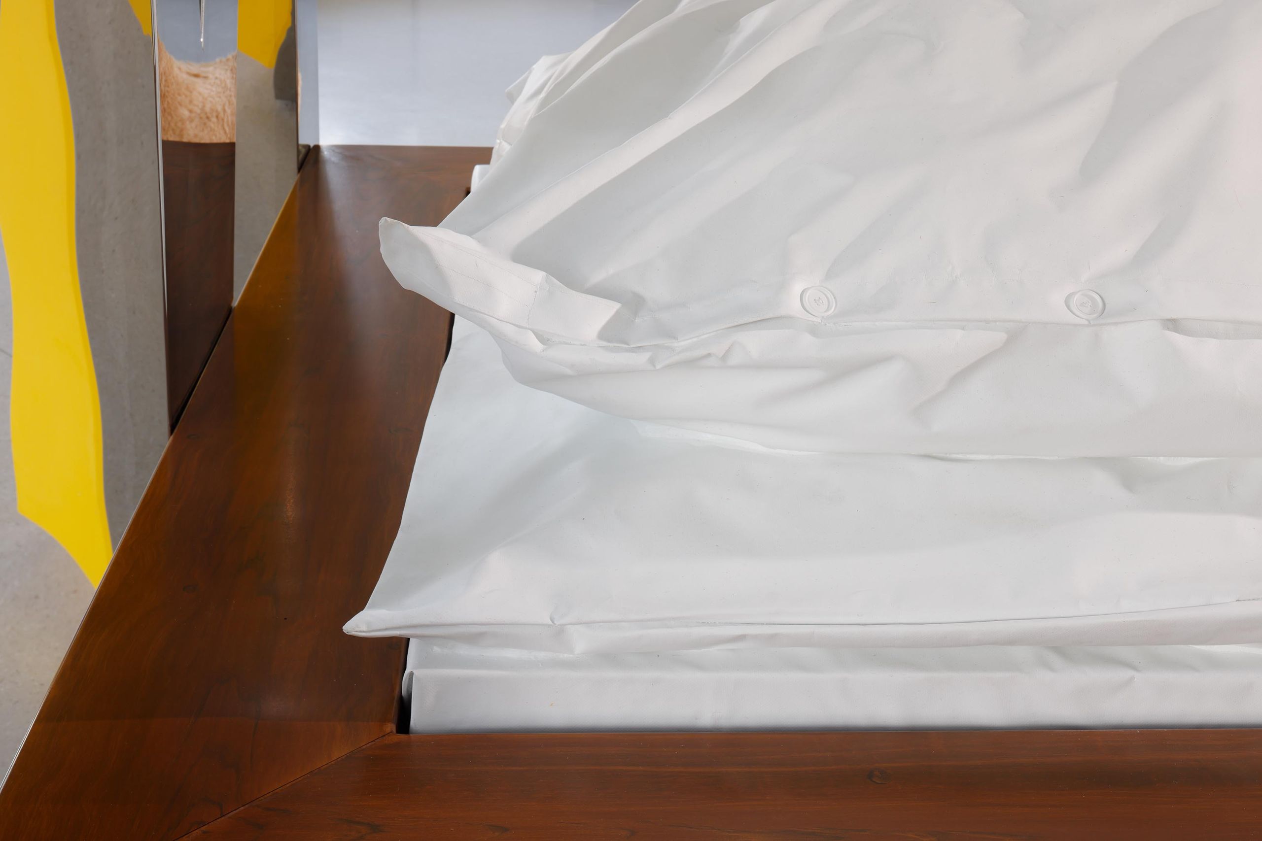 McBed: detail of the bedding and the walnut frame