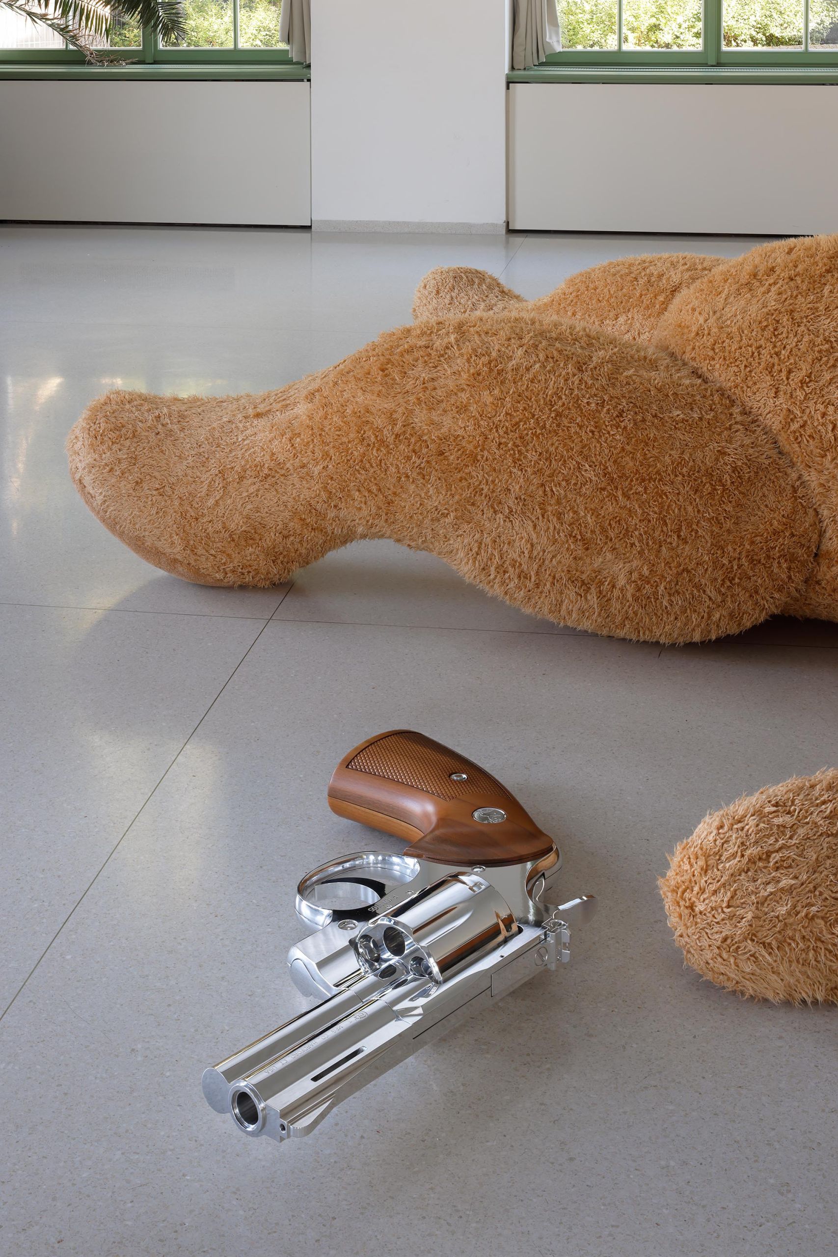 The chrome revolver beside the teddy bear